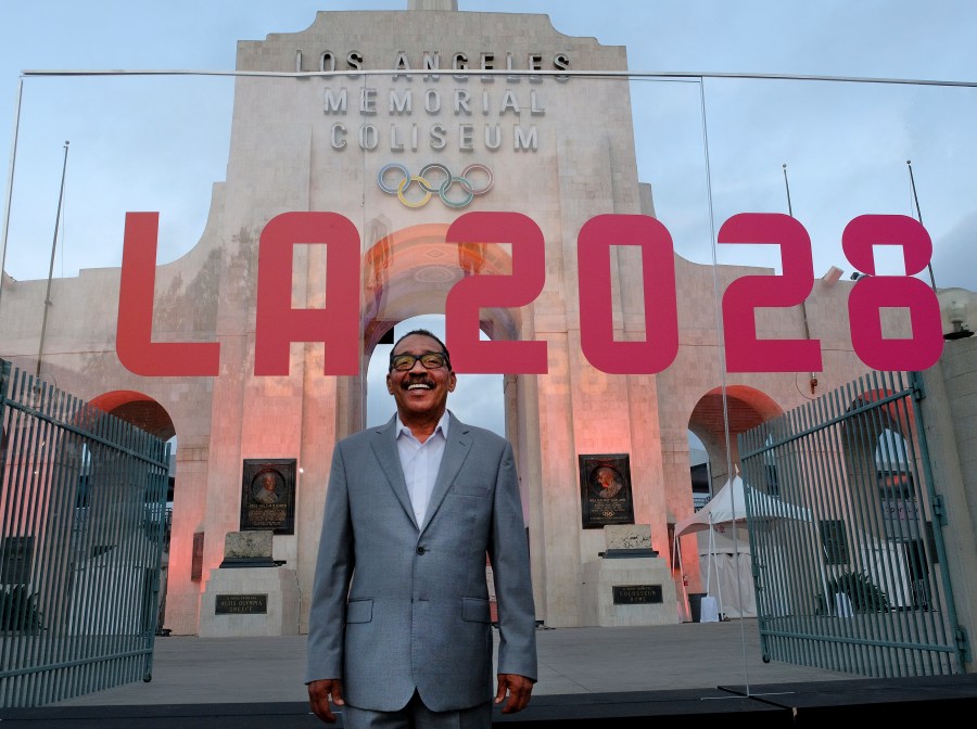 This Wednesday, Sept. 13, 2017 photo Los Angeles City Council President Herb Wesson stands at the Los Angeles Memorial Coliseum as the Olympic torch is lit. The cauldron was lit early Wednesday at the stadium that was the site of the 1932 and 1984 Olympics. An International Olympic Committee meeting in Peru made it's official announcement that LA will host in 2028 and that the 2024 Games will go to Paris. (AP Photo/Richard Vogel)