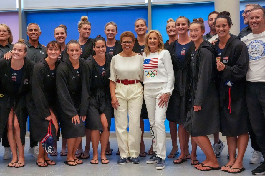 U.S. first lady Jill Biden and Los Angeles Mayor Karen Bass pose for a photo with the United States Olympic women's water polo team after their win over Greece, Satruday, July 27, 2024, in Paris, France. (Toni L. Sandys/The Washington Post via AP, Pool)