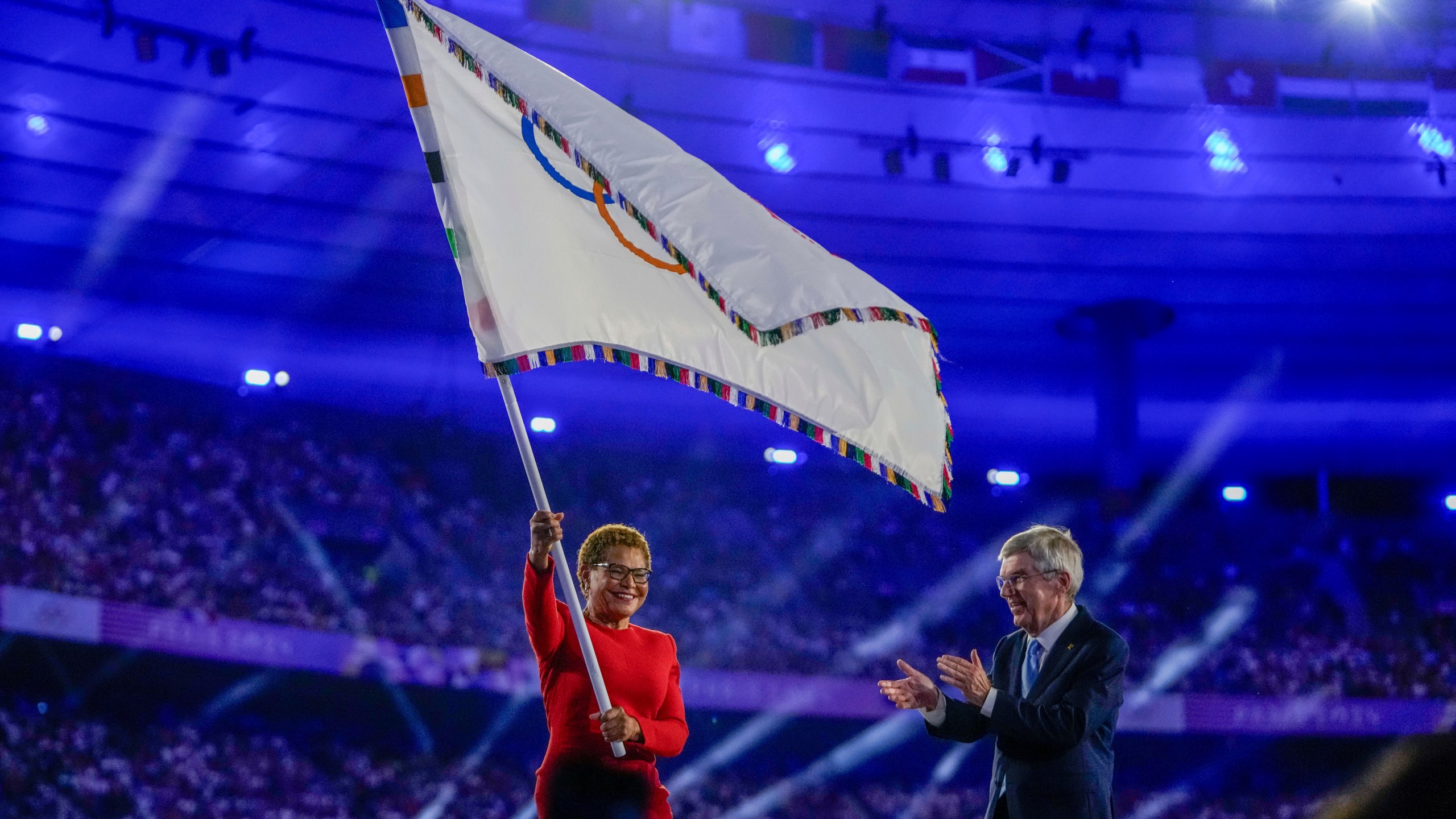Karen Bass waves Olympic flag
