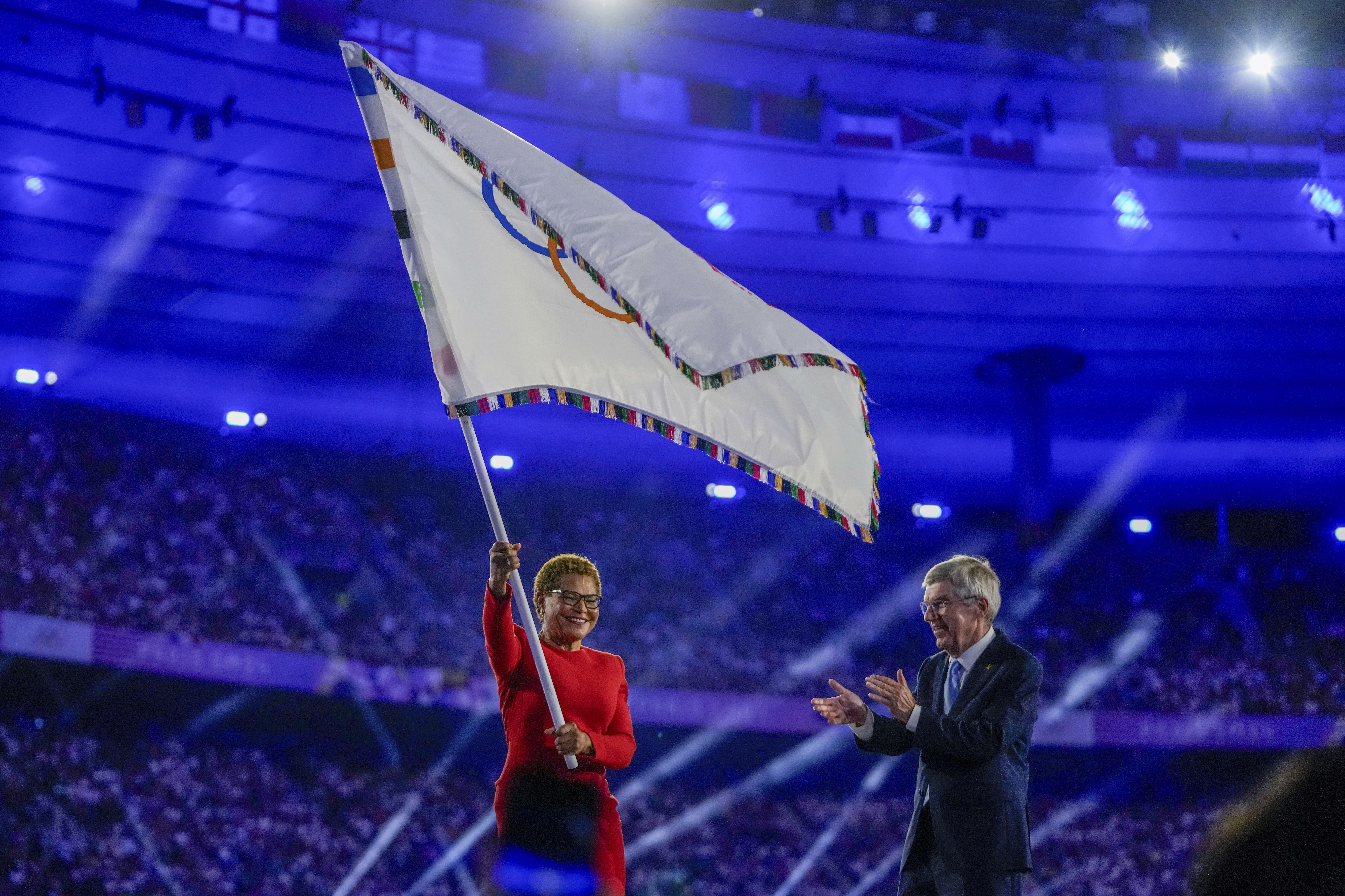 Karen Bass waves Olympic flag
