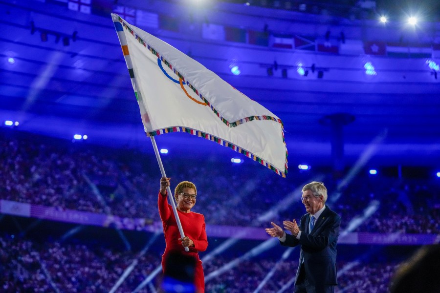 Karen Bass waves Olympic flag