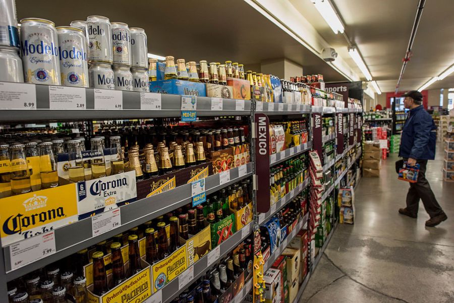 Corona Extra beer and Modelo Especial beer, distributed by Constellation Brands Inc., are displayed for sale on a shelf as a customer shops at a BevMo! store in San Francisco, California, U.S., on Tuesday, April 7, 2015. (Photographer: David Paul Morris/Bloomberg via Getty Images)