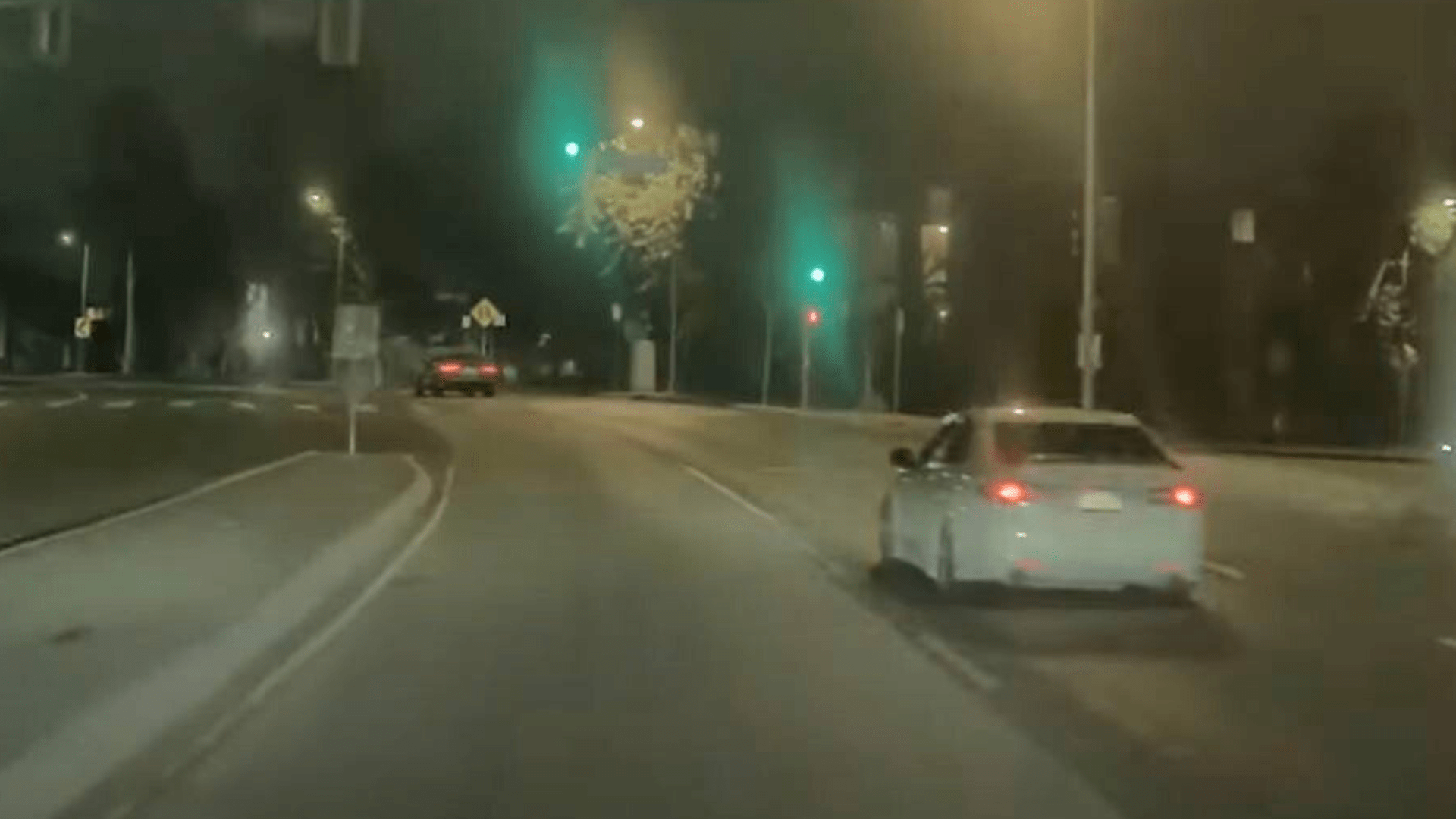 The suspect in white Acura sedan seen speeding up to the victim's gray BMW in Canoga Park on August 3, 2024. (Los Angeles Police Department)