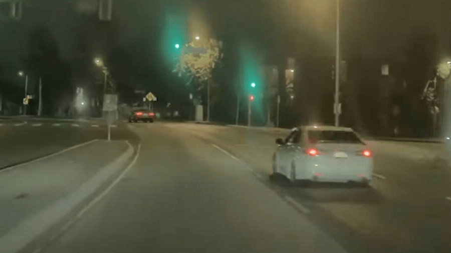 The suspect in white Acura sedan seen speeding up to the victim's gray BMW in Canoga Park on August 3, 2024. (Los Angeles Police Department)