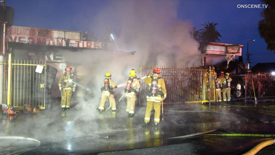 Firefighters battle a large blaze in front of a South L.A. tire shop on August 2, 2024. (OnScene.TV)