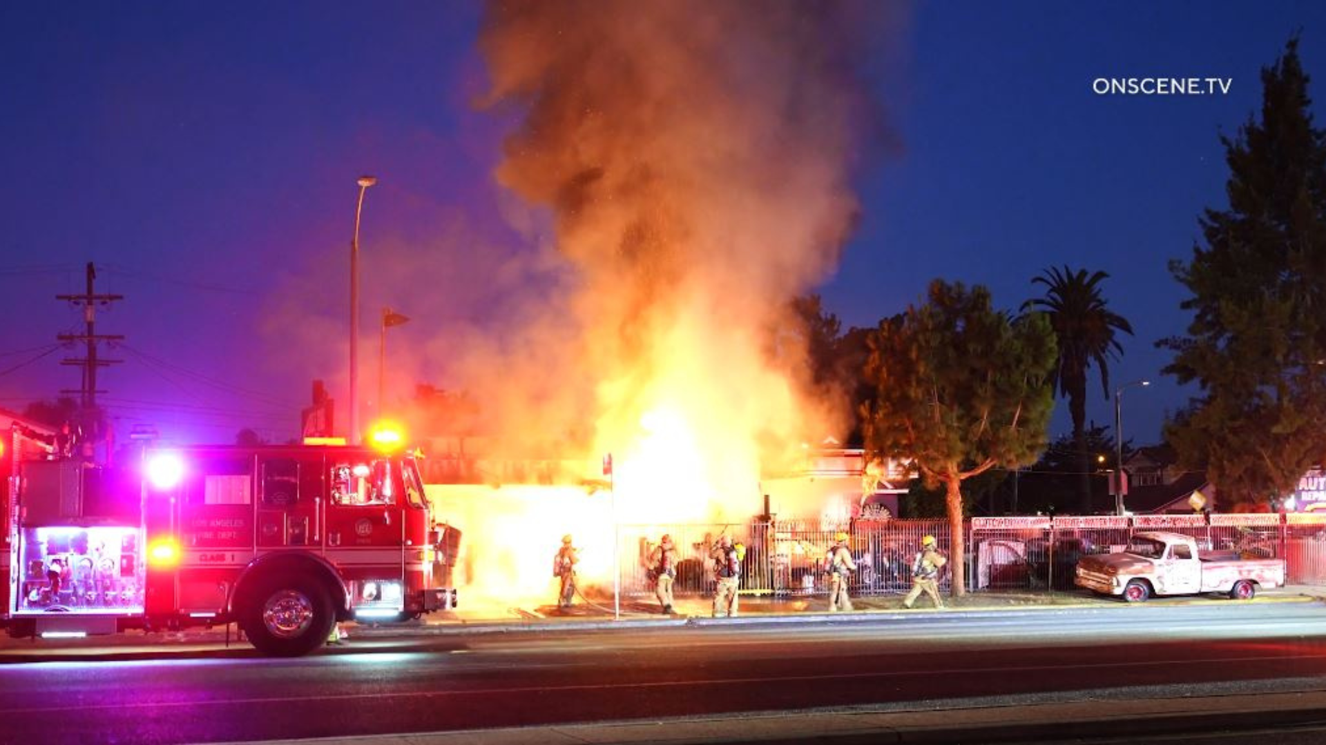 Firefighters battle a large blaze in front of a South L.A. tire shop on August 2, 2024. (OnScene.TV)