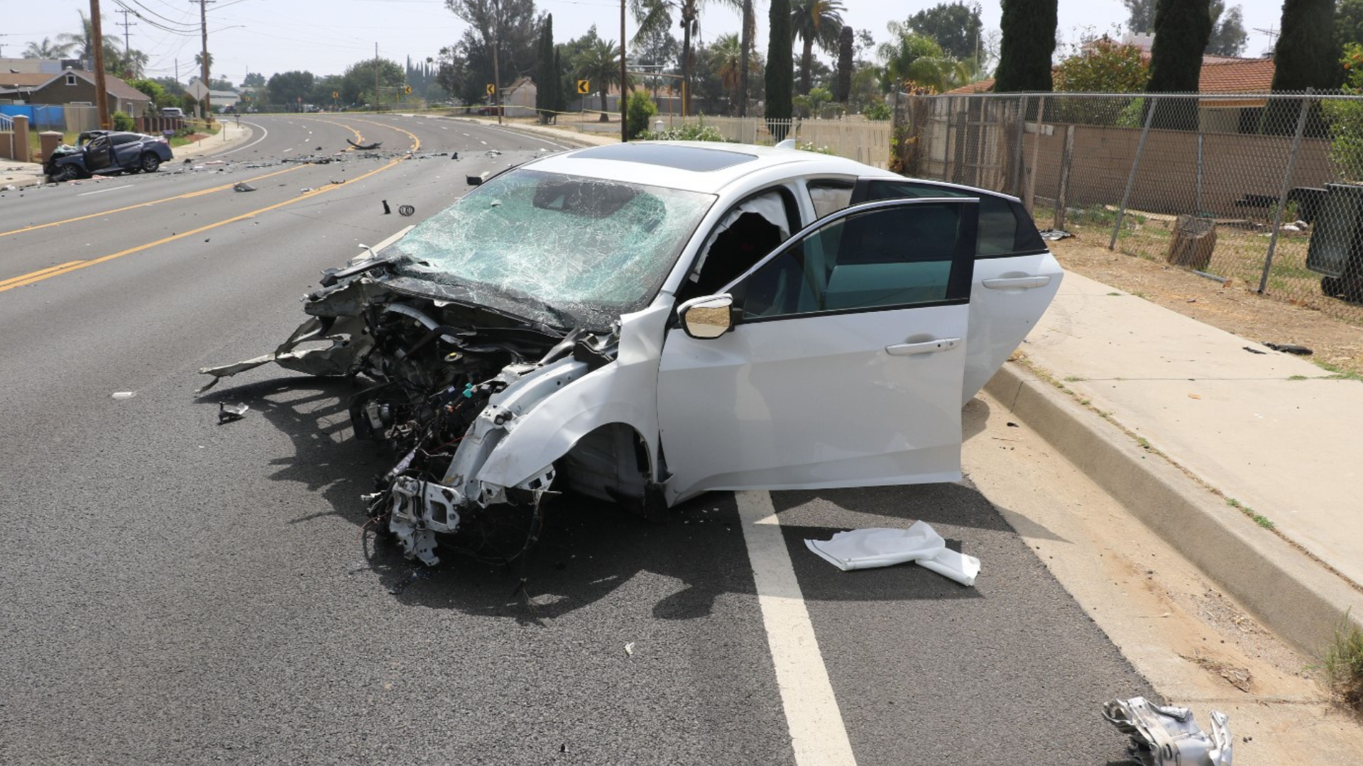 The suspect's white Honda was totaled after colliding head-on with another vehicle in a deadly Riverside crash on May 16, 2023. (Riverside Police Department)