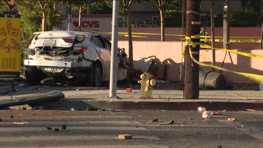 The suspect's white Lexus sedan crashed into a nearby wall after slamming into a pickup truck in Mission Hills on August 17, 2024. (KTLA)