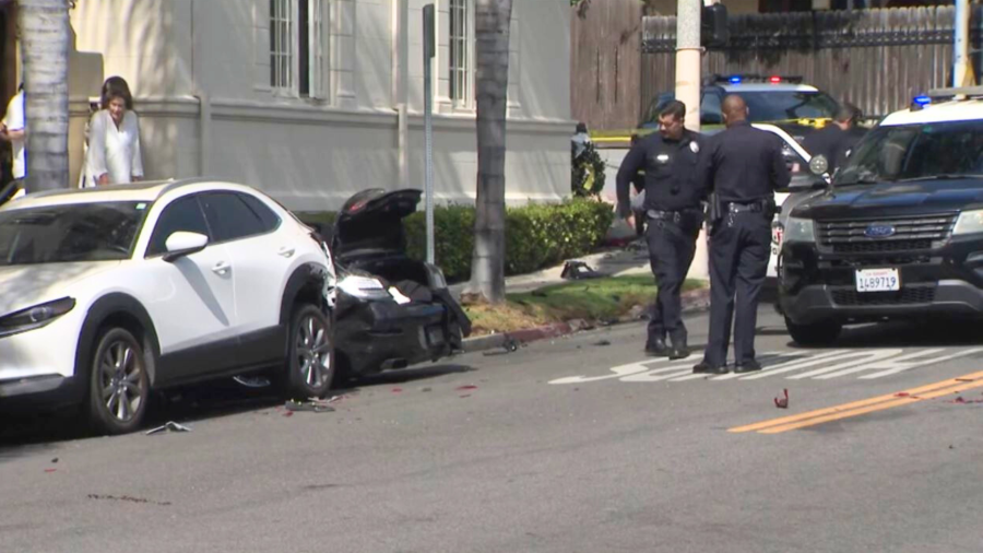 Police investigate the reportedly stolen BMW after a destructive pursuit crash in Koreatown on August 1, 2024. (KTLA)
