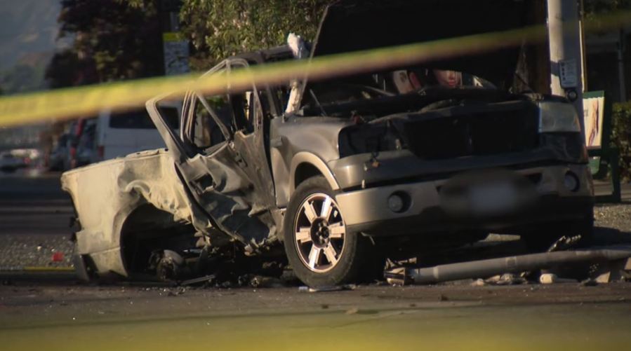 The Ford pickup truck was engulfed in flames as bystanders worked to rescue the trapped driver in Mission Hills on August 17, 2024. (KTLA)