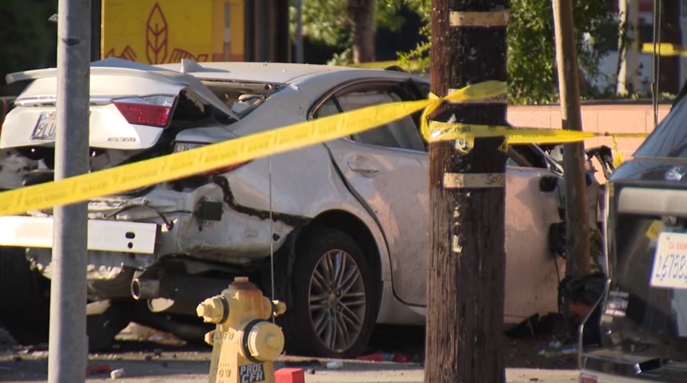 The suspect's white Lexus sedan crashed into a nearby wall after slamming into a pickup truck in Mission Hills on August 17, 2024. (KTLA)
