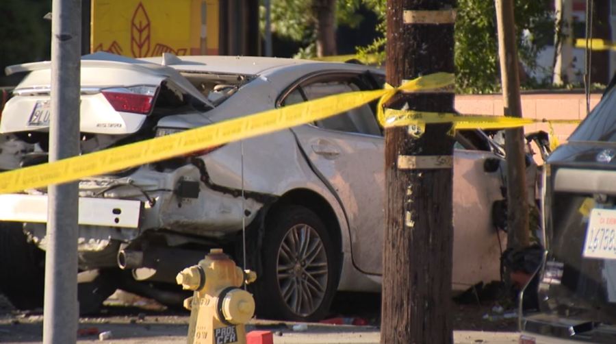 The suspect's white Lexus sedan crashed into a nearby wall after slamming into a pickup truck in Mission Hills on August 17, 2024. (KTLA)