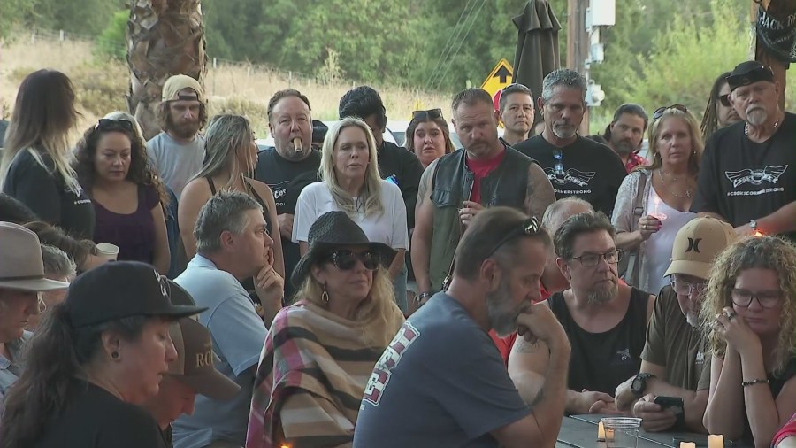 Community members and patrons gathered at Cook's Corner biker bar on August 23, 2024, for a prayer service and candlelight vigil honoring the victims of a 2023 mass shooting. (KTLA)