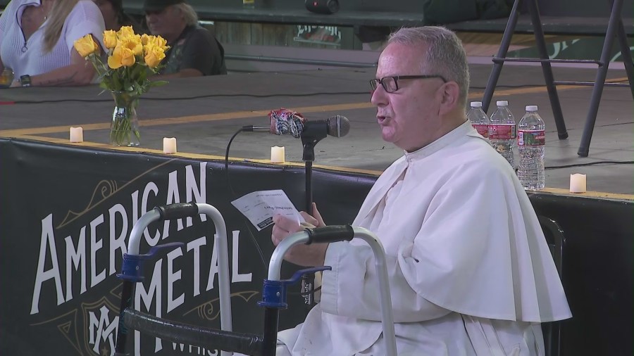 Community members and patrons gathered at Cook's Corner biker bar on August 23, 2024, for a prayer service and candlelight vigil honoring the victims of a 2023 mass shooting. (KTLA)