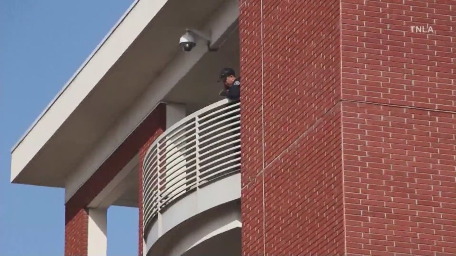 Police investigate the fifth story of the parking structure where the suspect reportedly jumped to his death from. (KTLA)