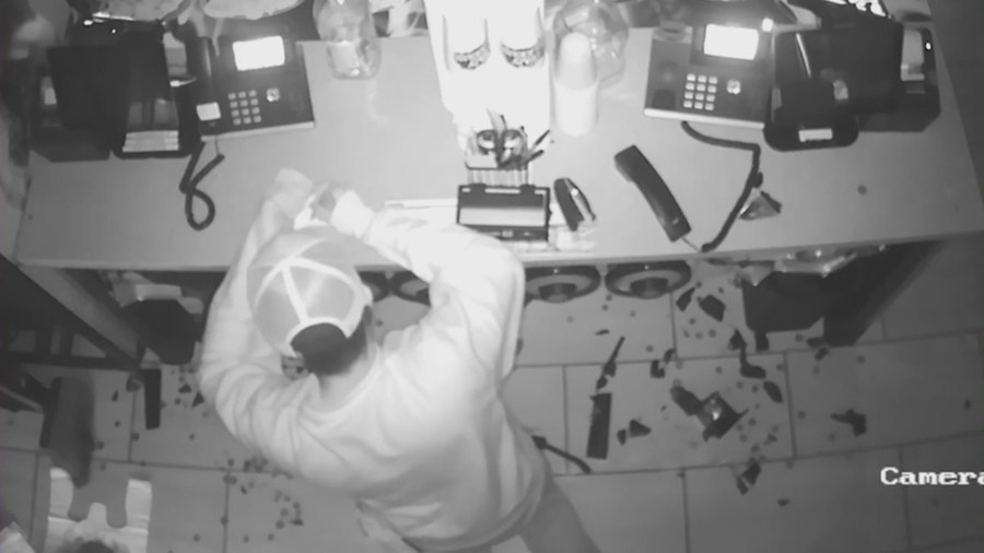 The thief is seen writing an apology note during a break-in at Teriyaki Madness. (Teriyaki Madness)