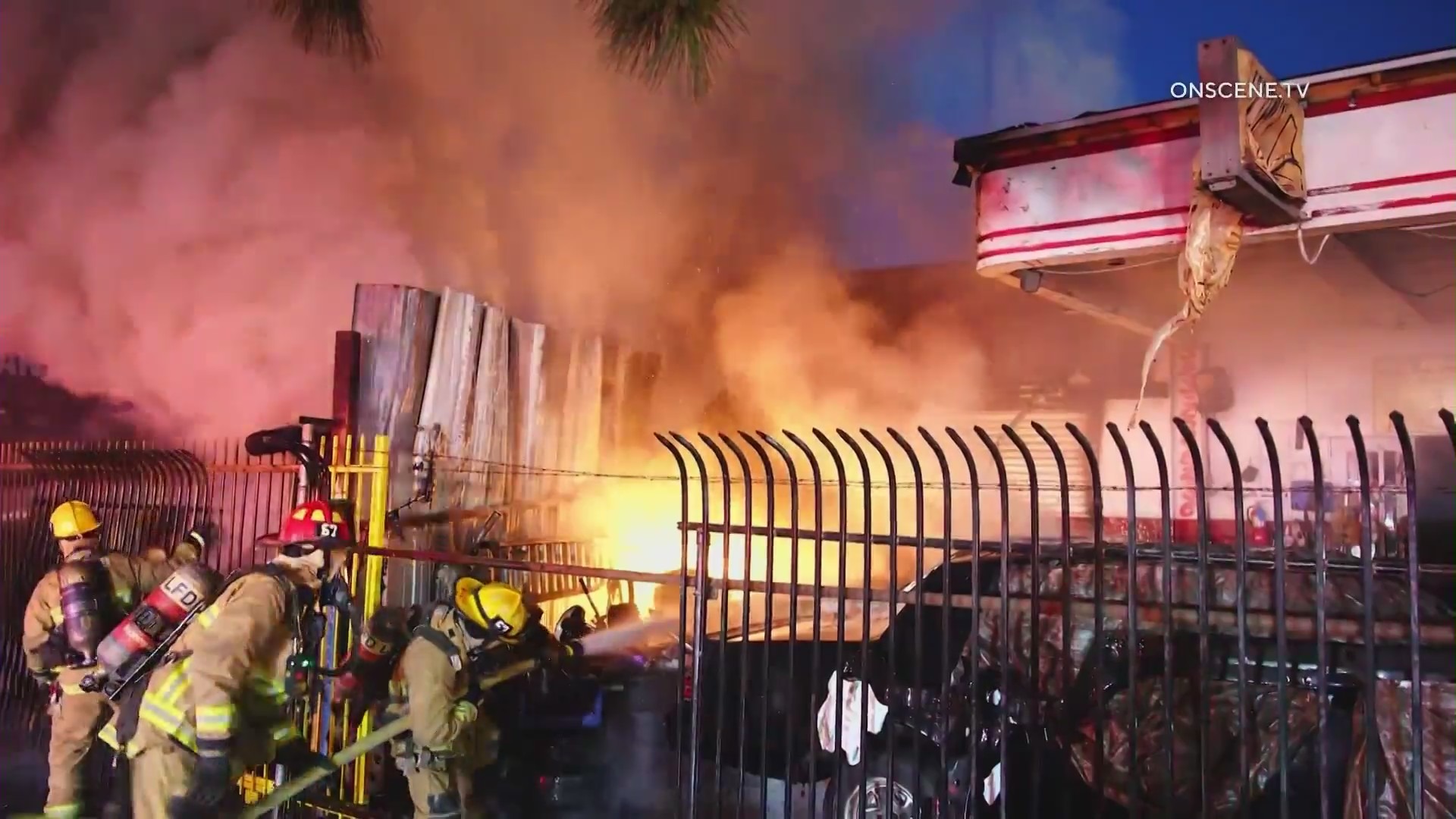 Firefighters battle a large blaze in front of a South L.A. tire shop on August 2, 2024. (OnScene.TV)