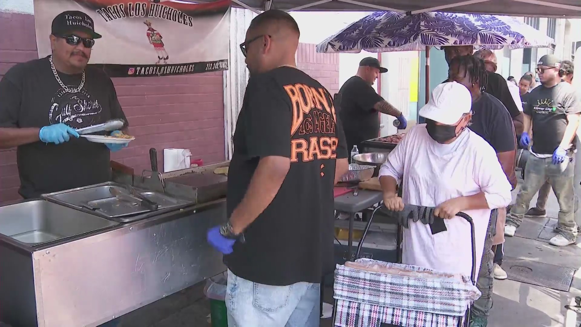 Chris Bailey's crew serves up food to homeless residents in downtown L.A.'s Skid Row. (KTLA)