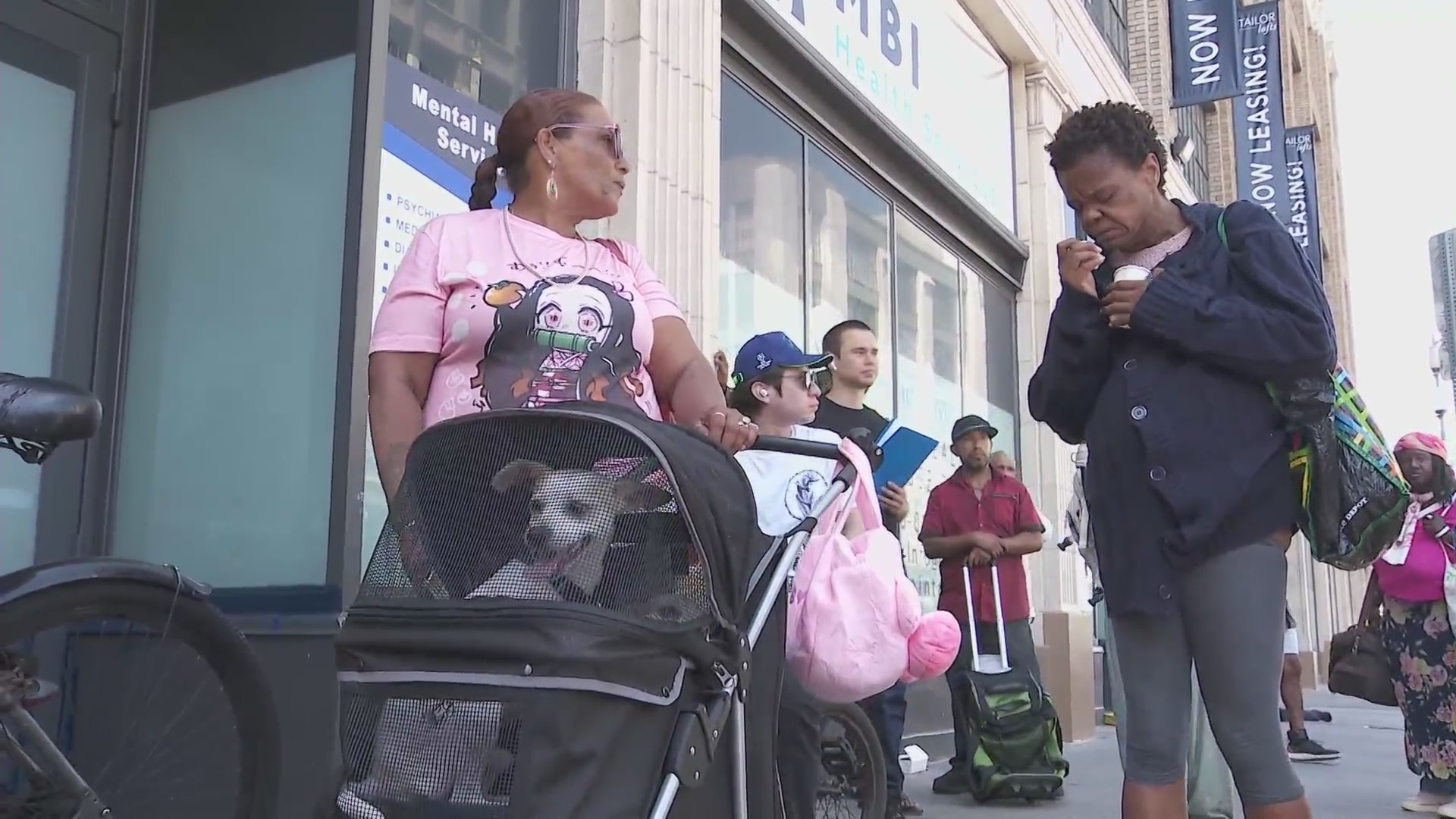 Long lines wrap around the block as hungry Skid Row residents await Chris Bailey's free meals. (KTLA)