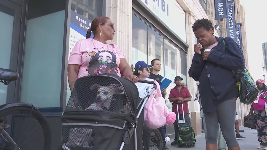 Long lines wrap around the block as hungry Skid Row residents await Chris Bailey's free meals. (KTLA)