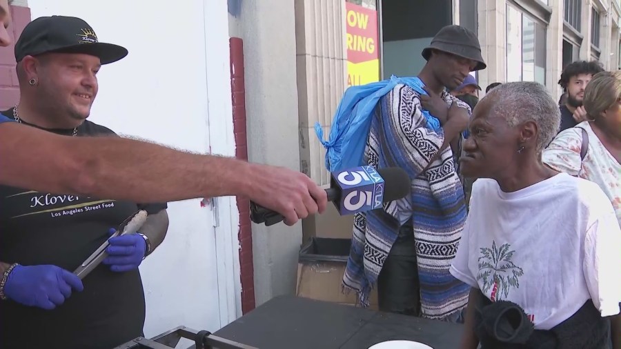 A thankful resident speaks to Chris Bailey and KTLA's John Fenoglio about her gratitude for the free meals. (KTLA)