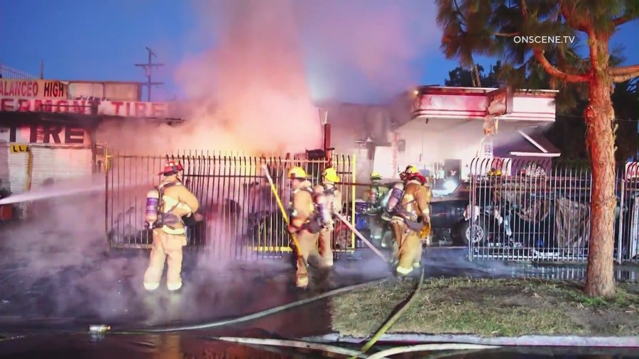 Firefighters battle a large blaze in front of a South L.A. tire shop on August 2, 2024. (OnScene.TV)