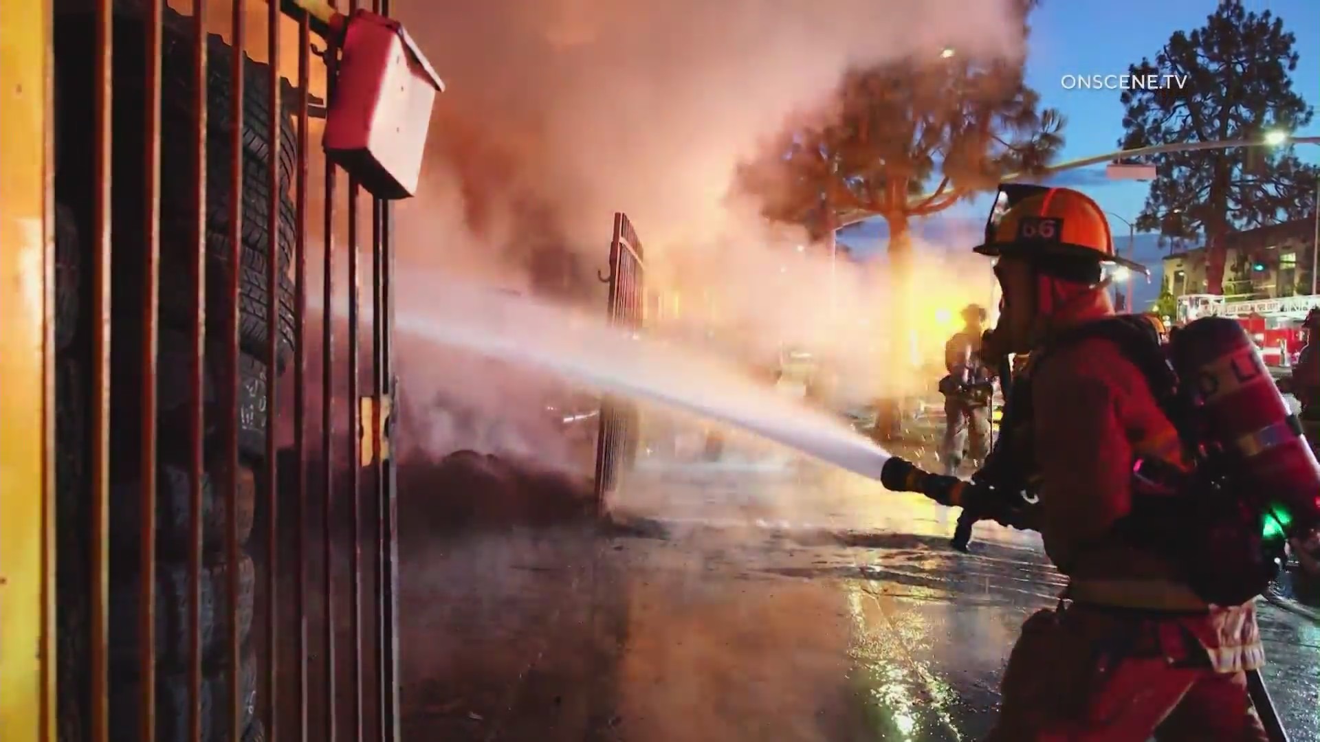 Firefighters battle a large blaze in front of a South L.A. tire shop on August 2, 2024. (OnScene.TV)