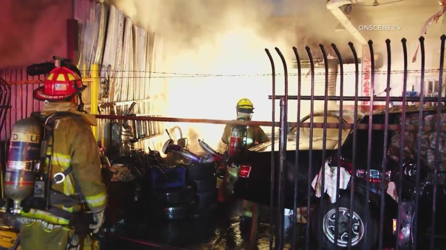 Firefighters battle a large blaze in front of a South L.A. tire shop on August 2, 2024. (OnScene.TV)