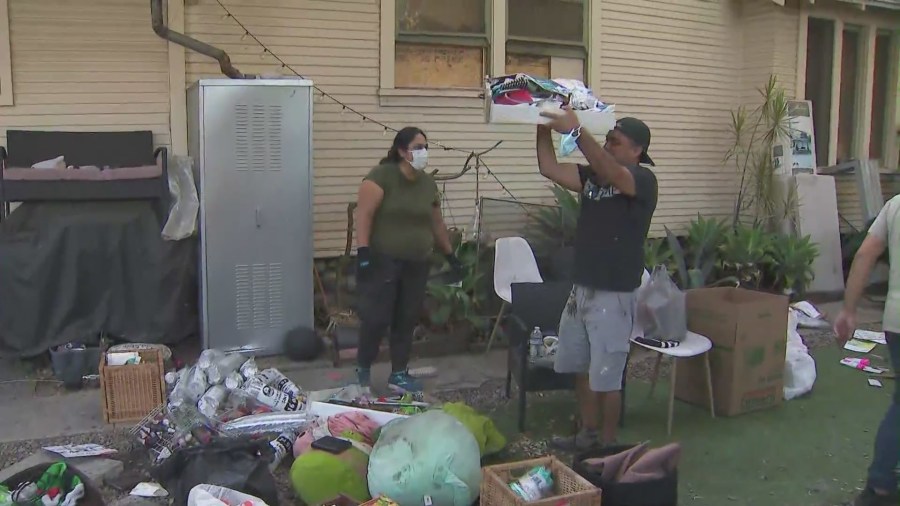 The Majano family, with the help of friends, family and neighbors, are salvaging whatever they can from their torched home. (KTLA)