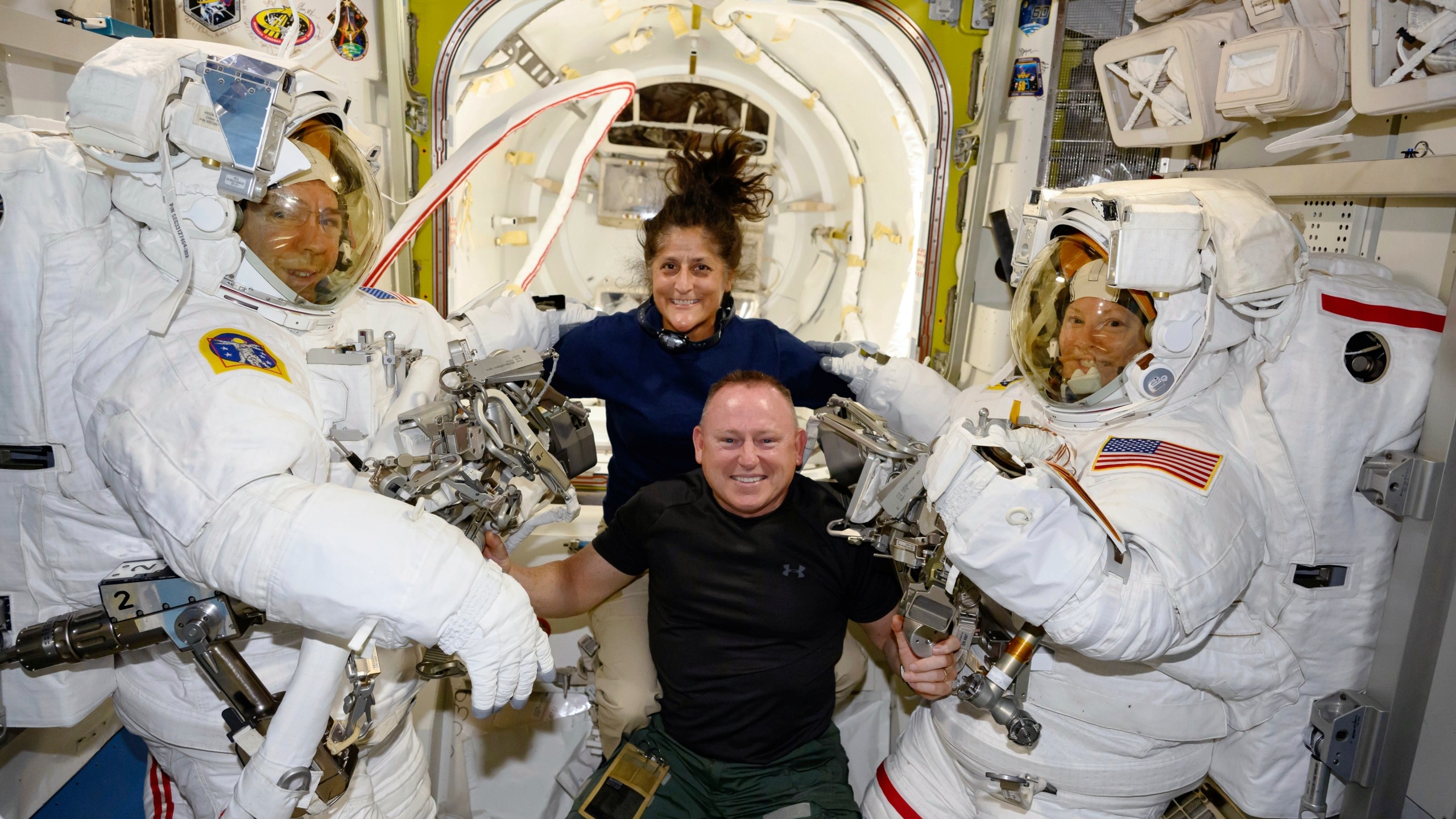FILE - In this photo provided by NASA, Boeing Crew Flight Test astronauts Suni Williams and Butch Wilmore, center, pose with Expedition 71 Flight Engineers Mike Barratt, left, and Tracy Dyson, aboard the International Space Station's Quest airlock on June 24, 2024. (NASA via AP, File)