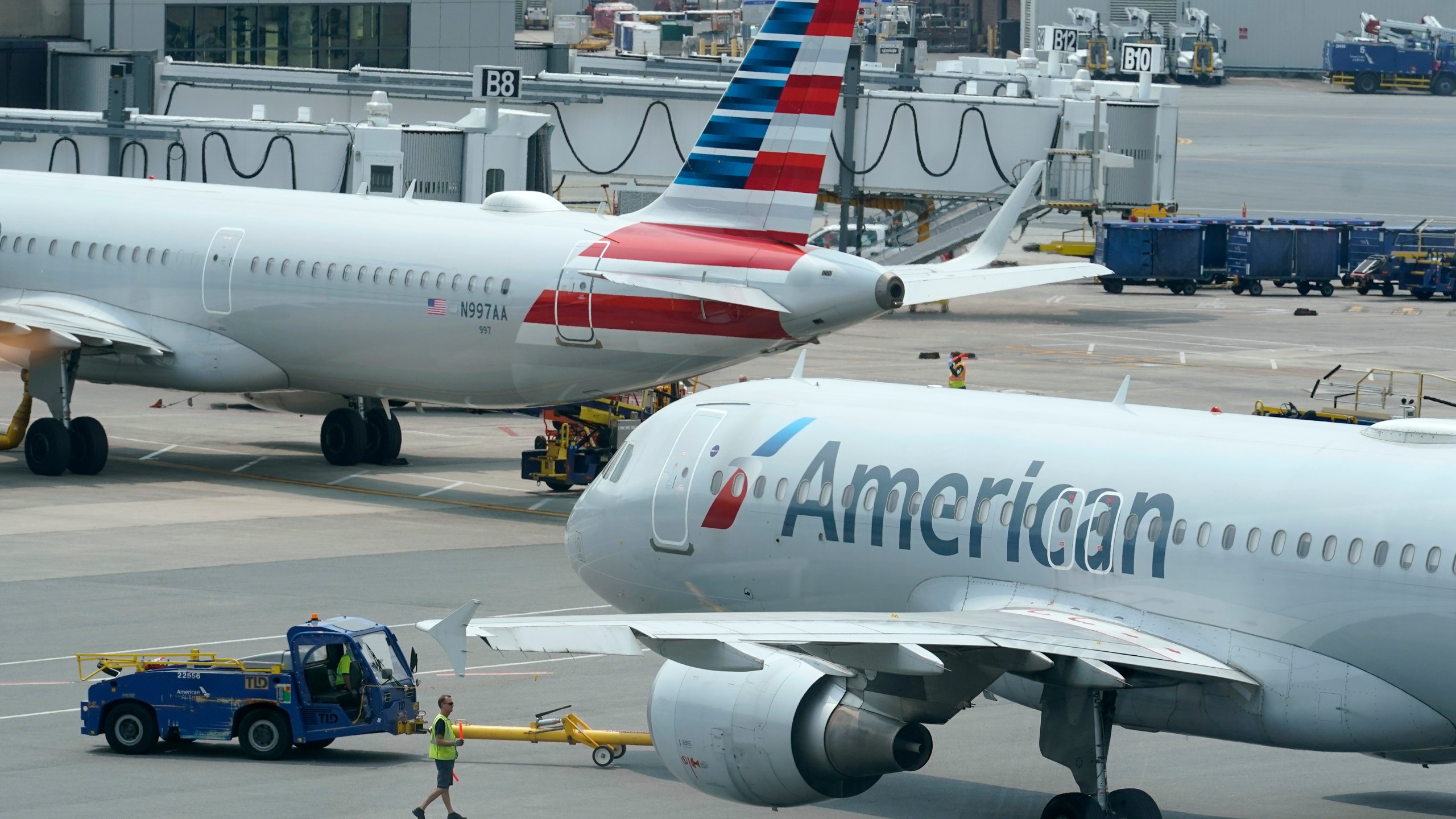 FILE - American Airlines passenger jets prepare for departure, July 21, 2021, near a terminal at Boston Logan International Airport in Boston. (AP Photo/Steven Senne, File)