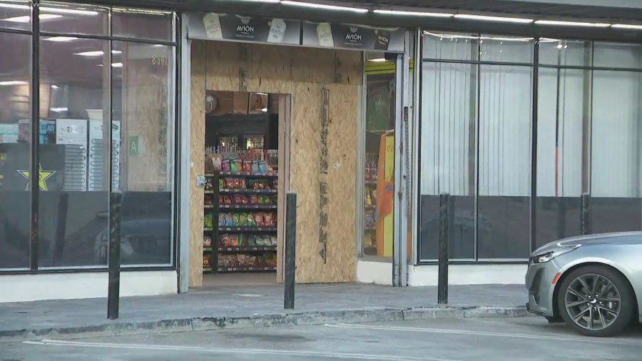 The entrance is boarded up at SDV Liquor Market in Sunland after burglars used a pickup truck to ram the front glass doors. (KTLA)
