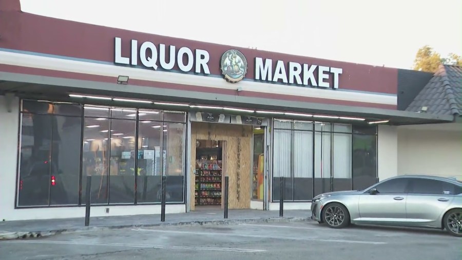 The entrance is boarded up at SDV Liquor Market in Sunland after burglars used a pickup truck to ram the front glass doors. (KTLA)