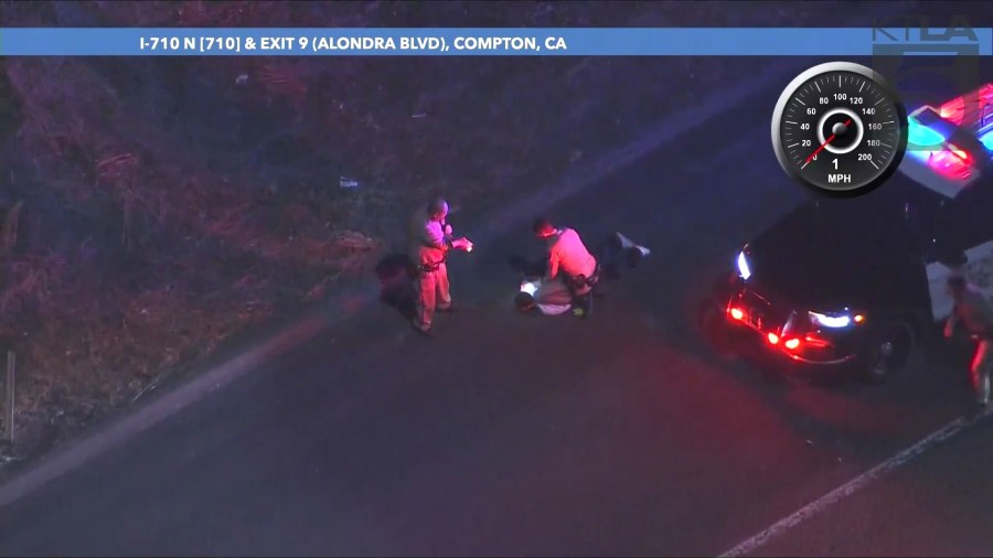 The two male suspects ditched the stolen car on the 710 Freeway in Compton and fled on foot before officers eventually found them. (KTLA)