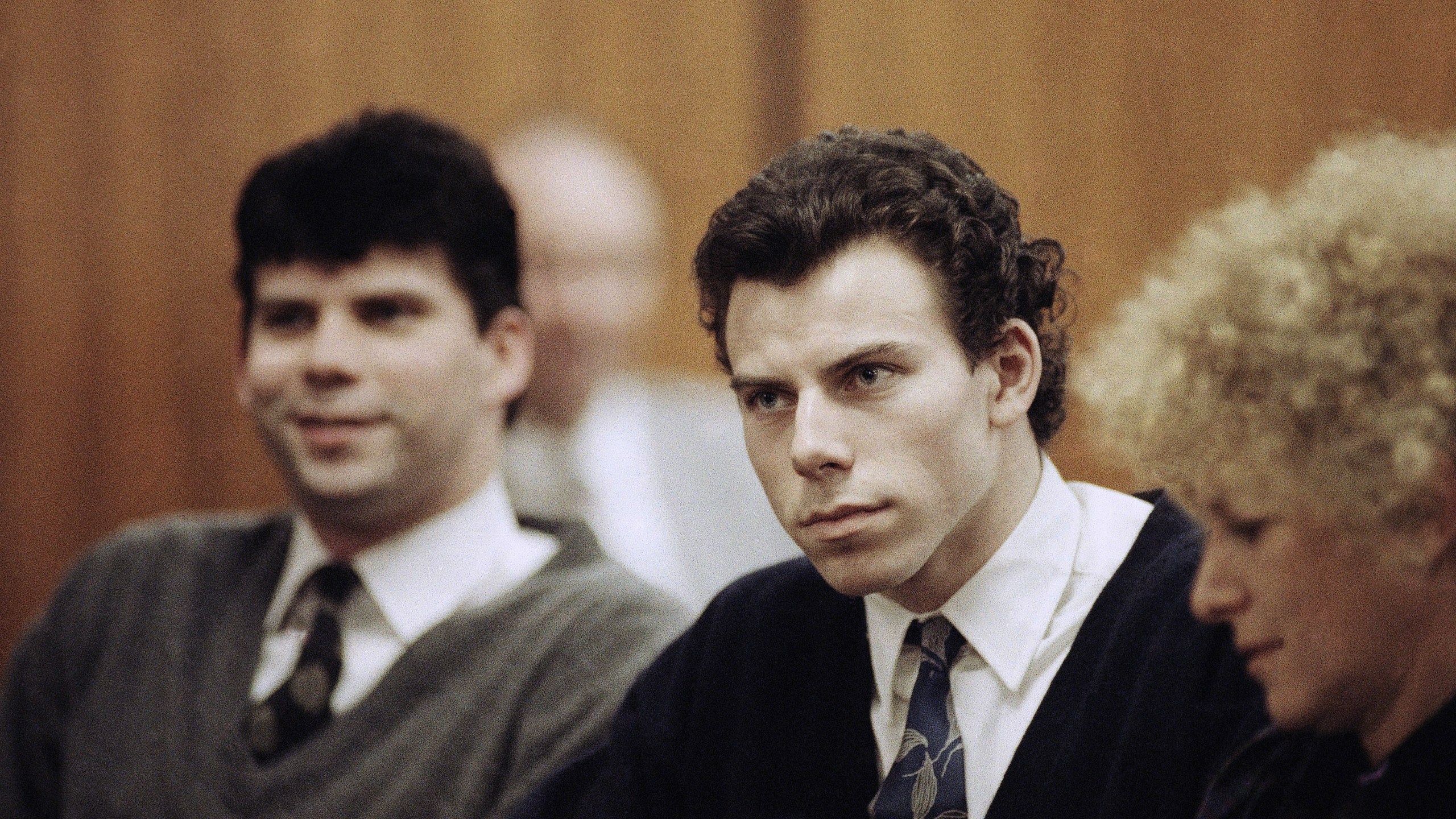 Lyle, left, and Erik Menendez sit with defense attorney Leslie Abramson, right, in Beverly Hills Municipal Court during a hearing, Nov. 26, 1990. (AP Photo/Nick Ut, File)