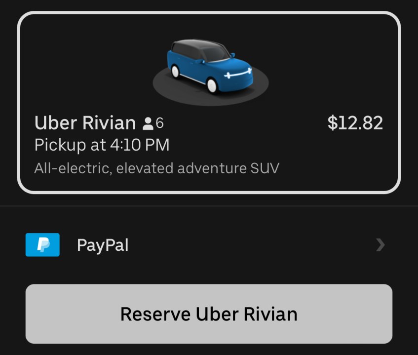 The Uber app shows a reservation screen for a Rivian vehicle during the company's EV popup event in Los Angeles on Oct. 23, 2024.