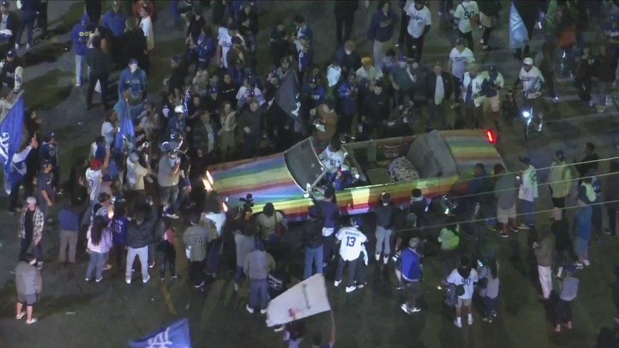 Crowds surrounded a car near Douglas Street and Sunset Boulevard to celebrate the Dodgers' World Series win on Oct. 30, 2024. (KTLA)