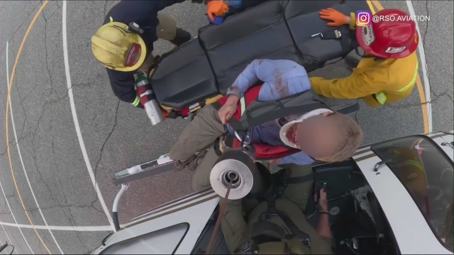 One hiker is seen injured and bloodied as rescuers airlift him from a rocky ravine to safety on Oct. 27, 2024. (@rsoaviation)