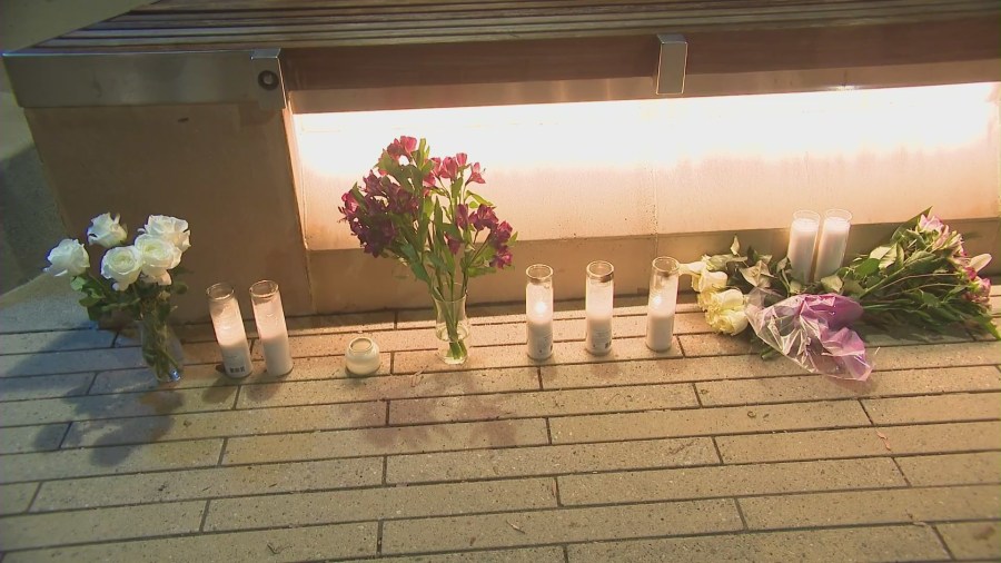 Flowers and candles were left at Santa Monica College's Center for Media and Design campus to honor Felicia Hudson on Oct. 16, 2024. (KTLA)