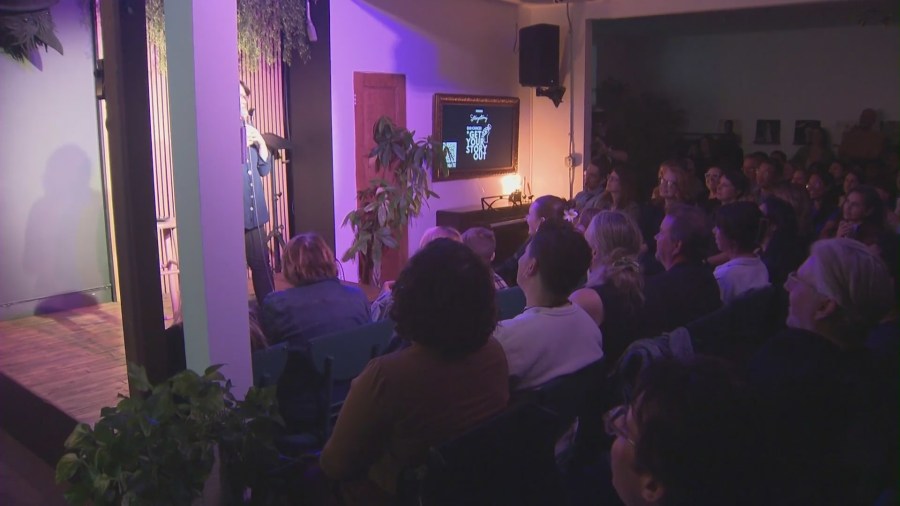 Audiences watch as Storyectomy participants share their stories at The Crow Comedy Club in Santa Monica. (KTLA)