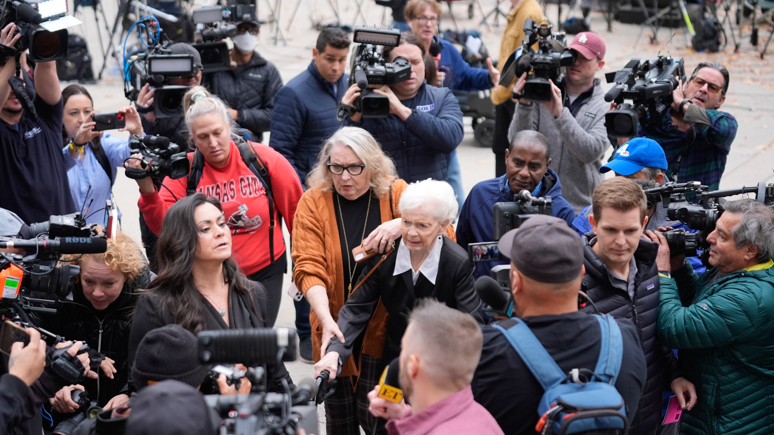 Erik and Lyle Menendez's aunt Joan VanderMolen, center, arrives to attend a hearing at the Van Nuys courthouse in Los Angeles, Monday, Nov. 25, 2024. (AP Photo/Damian Dovarganes)