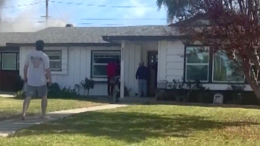 Neighbors were seen knocking on the victim's door to alert him of the growing fire on Nov. 30, 2024.