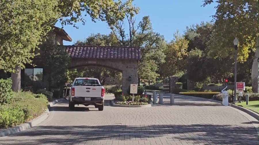 The entrance to the gated Valencia neighborhood where multiple burglaries were reported in the last several weeks. (KTLA)