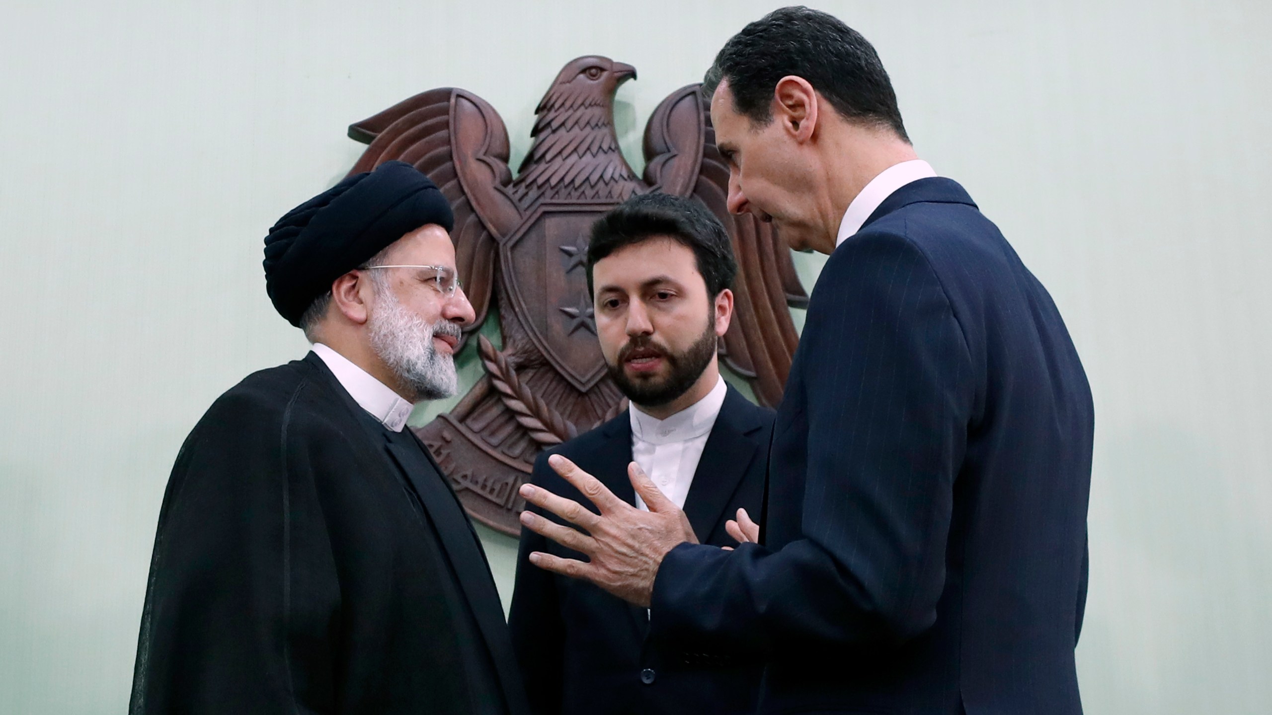 FILE - Syrian President Bashar Assad, right, speaks with Iranian President Ebrahim Raisi, left, in Damascus, Syria, May 3, 2023. (AP Photo/Omar Sanadiki, File)