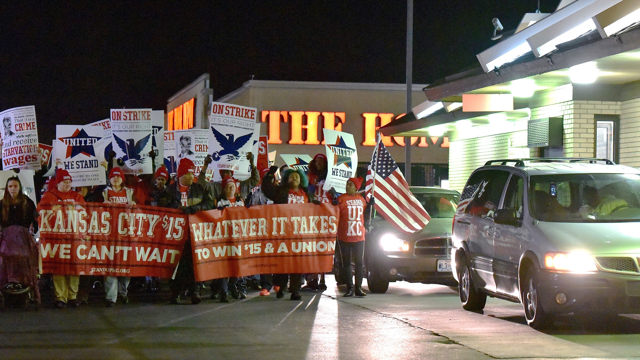 FILE - Protesters march around a McDonald's restaurant, Nov. 29, 2016, in Kansas City, Mo., as part of a national day of protest organized by Fight for $15 and United We Stand movements, seeking higher hourly wages, including for workers at fast-food restaurants and airports. (John Sleezer/The Kansas City Star via AP, file)