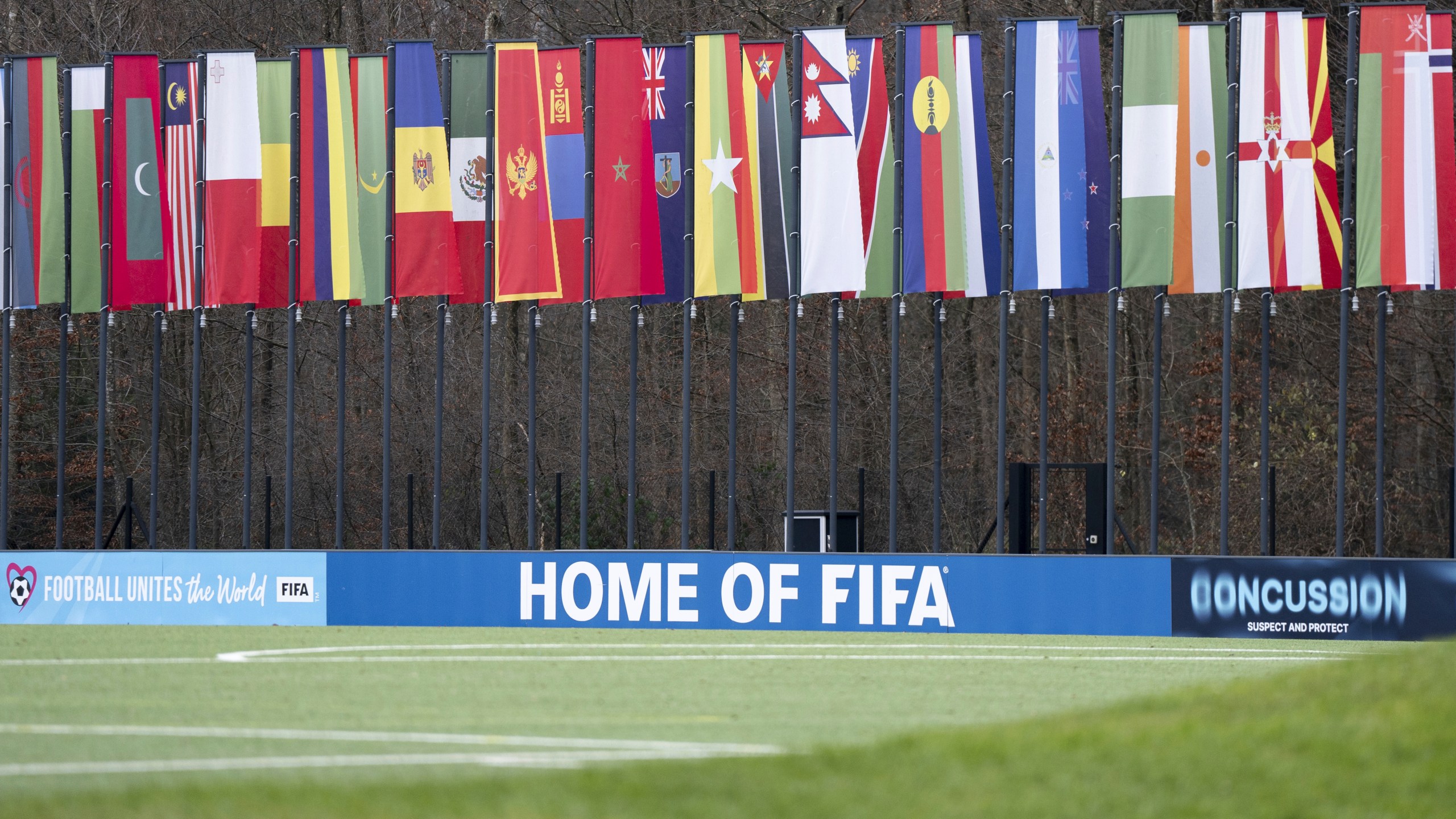 A soccer pitch with flags of the member states in the background is seen at the headquarters of the soccer association FIFA in Zurich, Switzerland, Wednesday, Dec. 11, 2024. (Til Buergy/Keystone via AP)