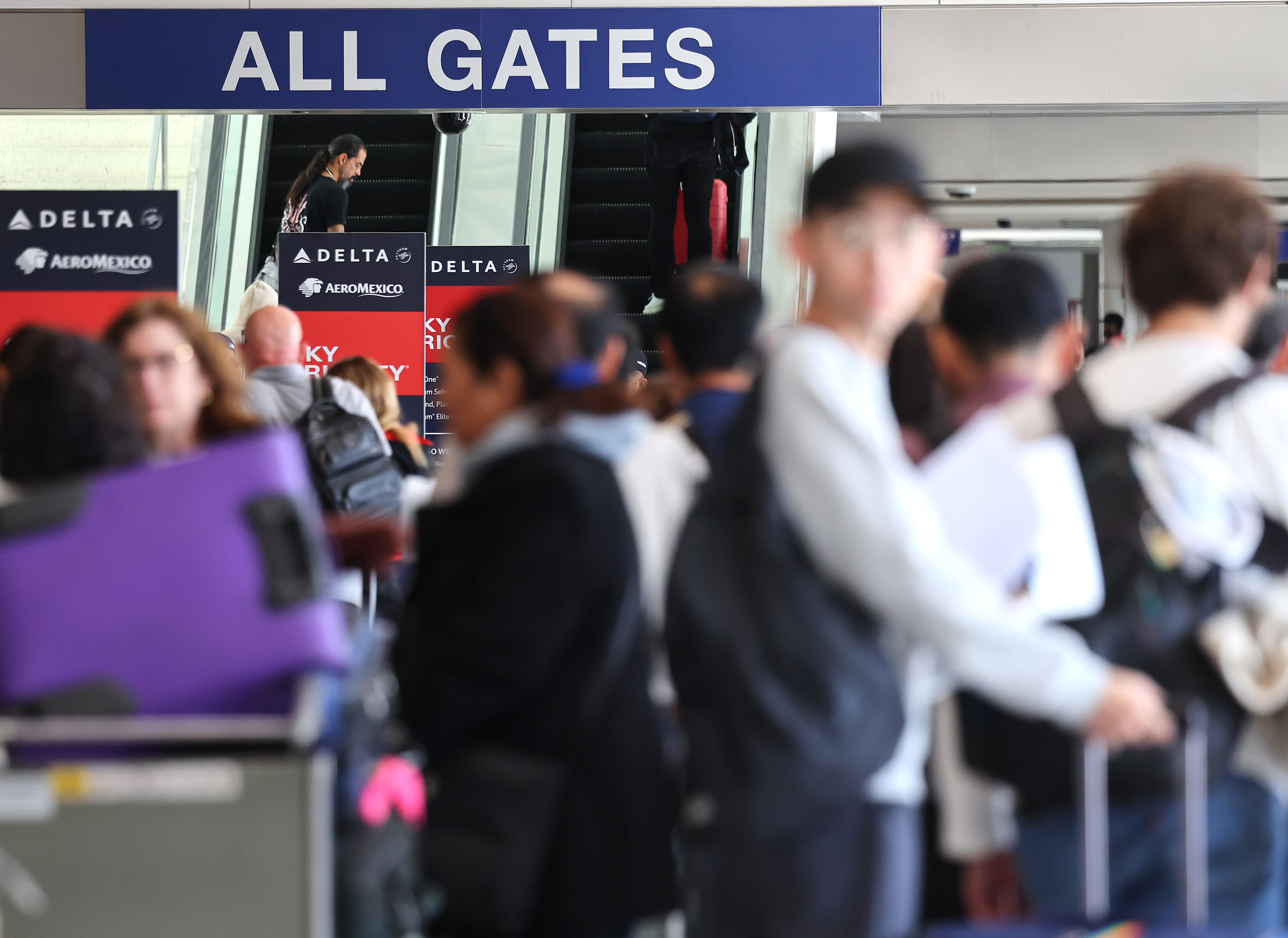 Travelers gather with their luggage in the Delta terminal at Los Angeles International Airport (LAX) following the Thanksgiving holiday on December 2, 2024 in Los Angeles, California. (Photo by Mario Tama/Getty Images)