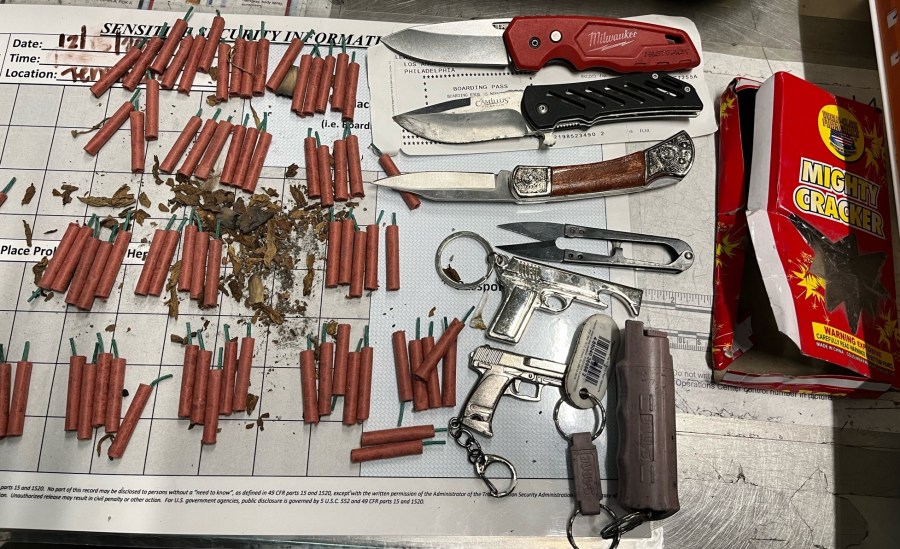This photo from the TSA shows firecrackers, knives and other prohibited items that were found in a woman's carry-on bag at LAX on Dec. 15, 2024. (Transportation Security Administration)