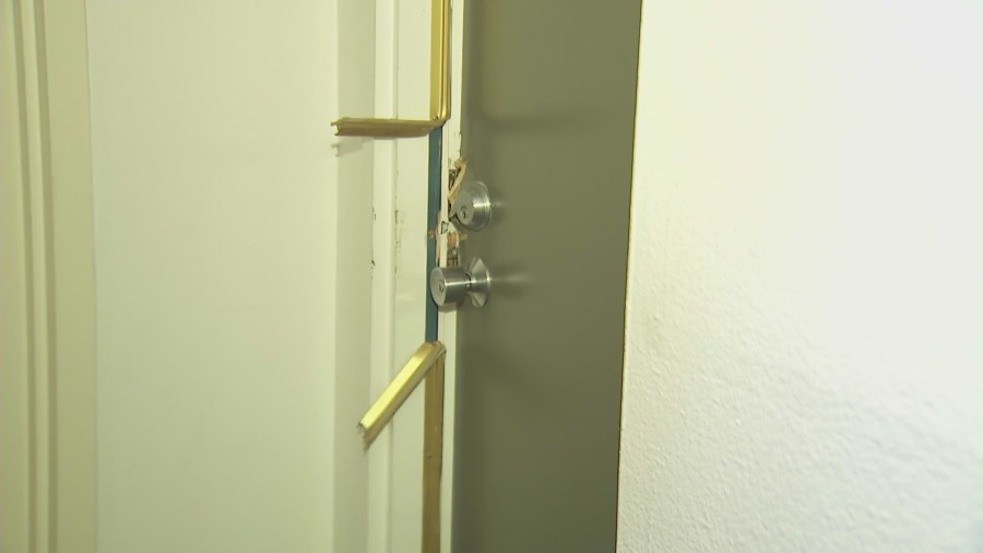 A victim's front door was smashed in by burglars who ransacked a Playa del Rey condominium complex in December 2024. (KTLA)