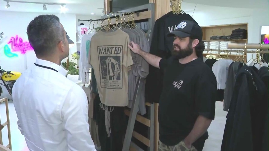 James Ingold, owner and founder of Vardagen, shows KTLA's Carlos Saucedo his new "Wanted" collection featuring the shoplifting suspect on Dec. 3, 2024. (KTLA)